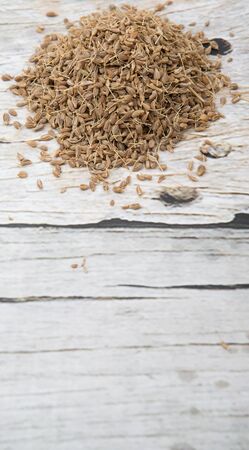 Dried anise seed or aniseed over wooden backgroundの写真素材