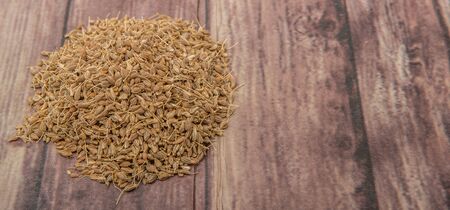 Dried anise seed or aniseed over wooden backgroundの写真素材