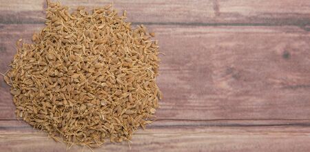 Dried anise seed or aniseed over wooden backgroundの写真素材