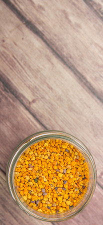 Bee pollen in a mason jar over wooden backgroundの写真素材