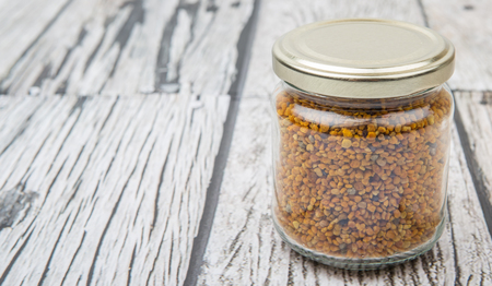 Bee pollen in a mason jar over wooden backgroundの写真素材