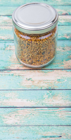 Bee pollen in a mason jar over wooden backgroundの写真素材
