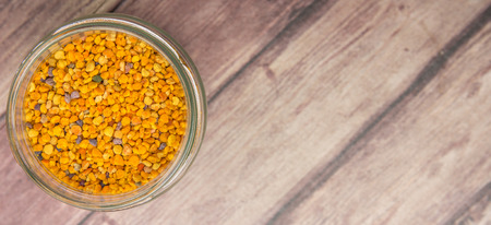 Bee pollen in a mason jar over wooden backgroundの写真素材
