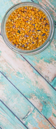 Bee pollen in a mason jar over wooden backgroundの写真素材