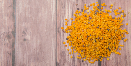 Bee pollen over wooden backgroundの写真素材