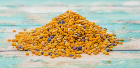 Bee pollen over wooden backgroundの写真素材