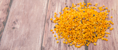 Bee pollen over wooden backgroundの写真素材