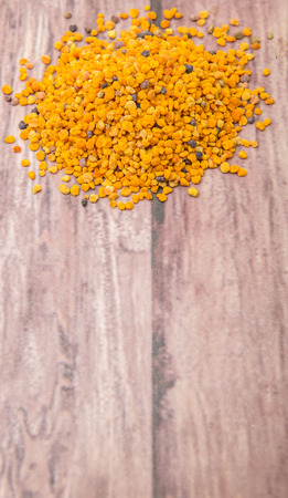 Bee pollen over wooden backgroundの写真素材