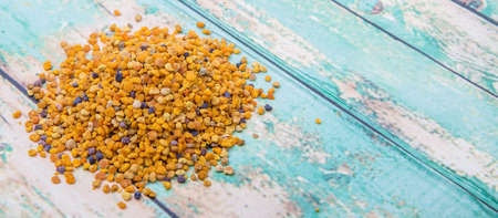 Bee pollen over wooden backgroundの写真素材