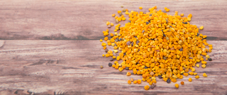 Bee pollen over wooden backgroundの写真素材