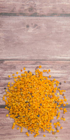 Bee pollen over wooden backgroundの写真素材