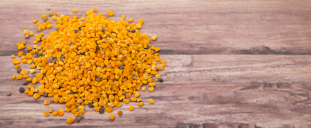 Bee pollen over wooden backgroundの写真素材