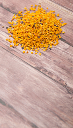 Bee pollen over wooden backgroundの写真素材
