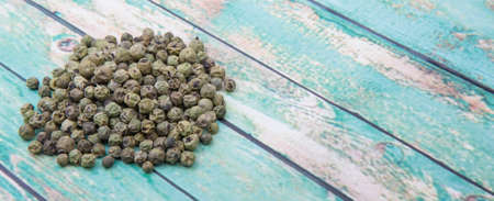 Dried green peppercorn wooden backgroundの写真素材