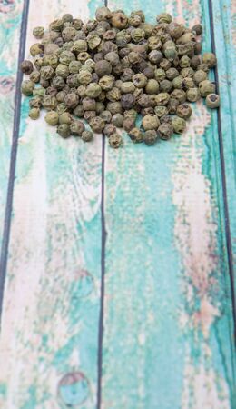 Dried green peppercorn wooden backgroundの写真素材