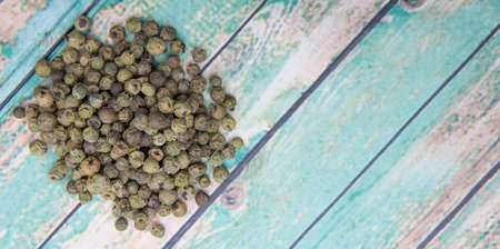 Dried green peppercorn wooden backgroundの写真素材