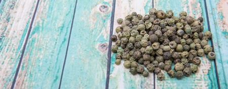 Dried green peppercorn wooden backgroundの写真素材