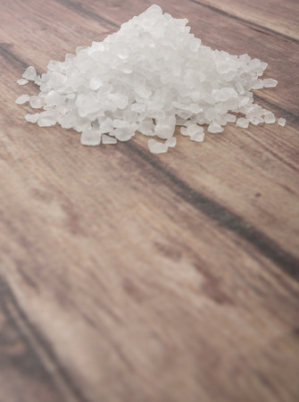 Sea salt over wooden backgroundの写真素材