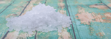 Sea salt over wooden background