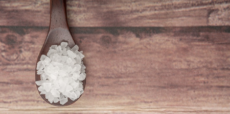 Sea salt over wooden backgroundの写真素材