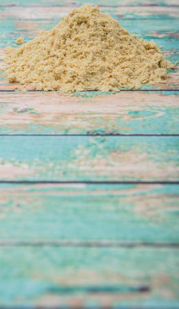 Ground mustard powder over wooden backgroundの写真素材