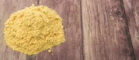 Ground mustard powder over wooden backgroundの写真素材