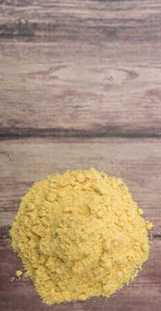 Ground mustard powder over wooden backgroundの写真素材