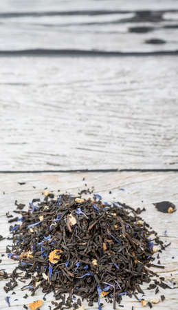 Dried black Earl Grey tea leaves over wooden backgroundの写真素材