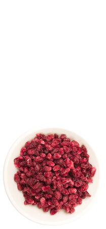 Dried pomegranate seeds in white bowl over white backgroundの写真素材