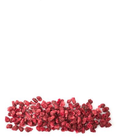 Dried pomegranate seeds in white bowl over wooden backgroundの写真素材