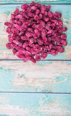 Dried pomegranate seeds over wooden backgroundの写真素材