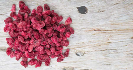 Dried pomegranate seeds over wooden backgroundの写真素材