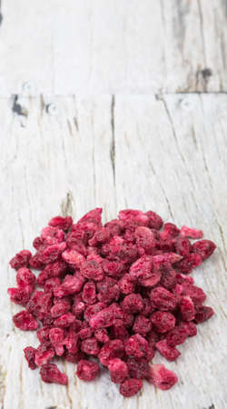 Dried pomegranate seeds over wooden backgroundの写真素材