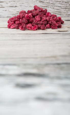 Dried pomegranate seeds over wooden backgroundの写真素材