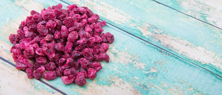 Dried pomegranate seeds over wooden backgroundの写真素材