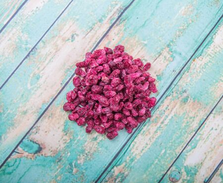 Dried pomegranate seeds over wooden backgroundの写真素材