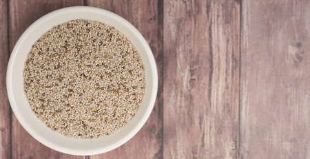 White chia seed in white bowl over wooden backgroundの写真素材