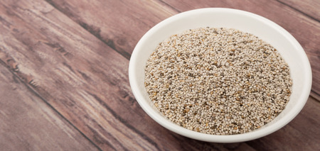 White chia seed in white bowl over wooden backgroundの写真素材