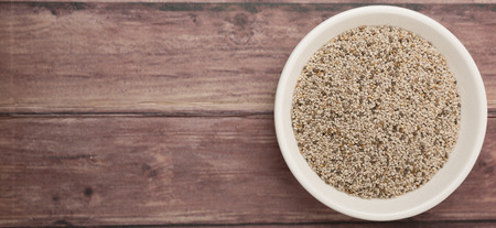 White chia seed in white bowl over wooden backgroundの写真素材