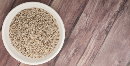 White chia seed in white bowl over wooden backgroundの写真素材