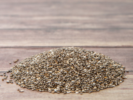 Dried black chia seed over wooden backgroundの写真素材