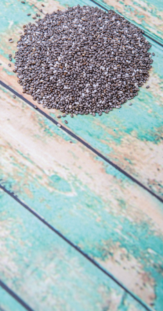 Dried black chia seed over wooden backgroundの写真素材