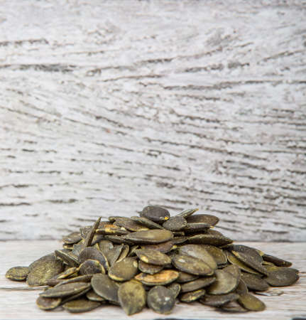 Roasted pumpkin seed over wooden backgroundの写真素材