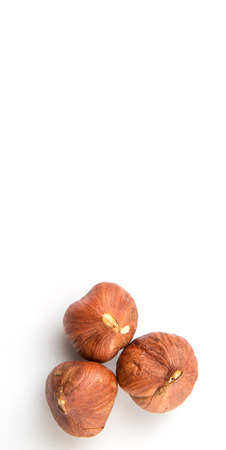 Peeled hazelnut nut over white backgroundの写真素材