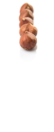 Peeled hazelnut nut over white backgroundの写真素材