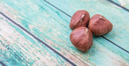Peeled hazelnut nut over wooden backgroundの写真素材