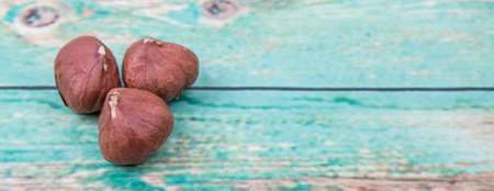 Peeled hazelnut nut over wooden backgroundの写真素材