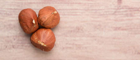 Peeled hazelnut nut over wooden backgroundの写真素材
