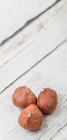 Peeled hazelnut nut over wooden backgroundの写真素材