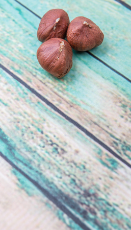 Peeled hazelnut nut over wooden background